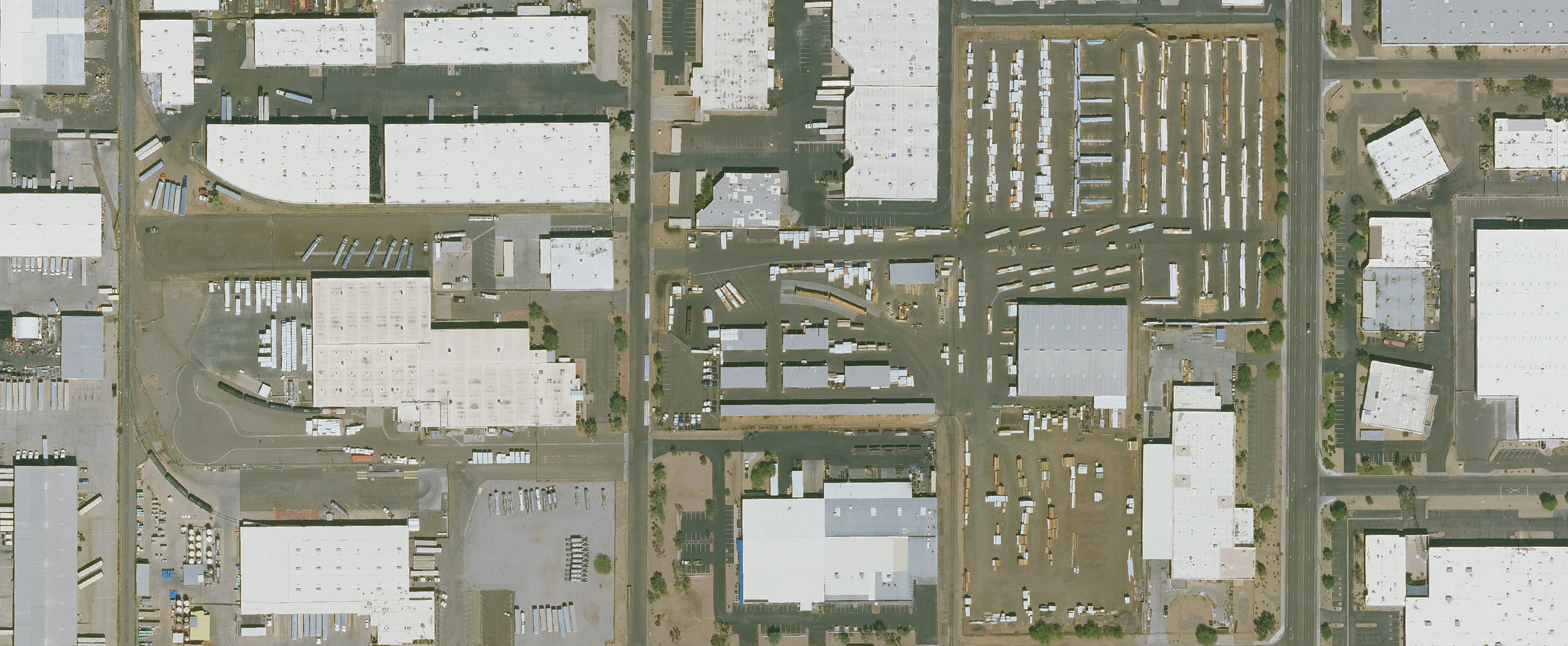 Wide public-domain aerial view of a working distribution yard and its surrounding operating area. The location is not identified.